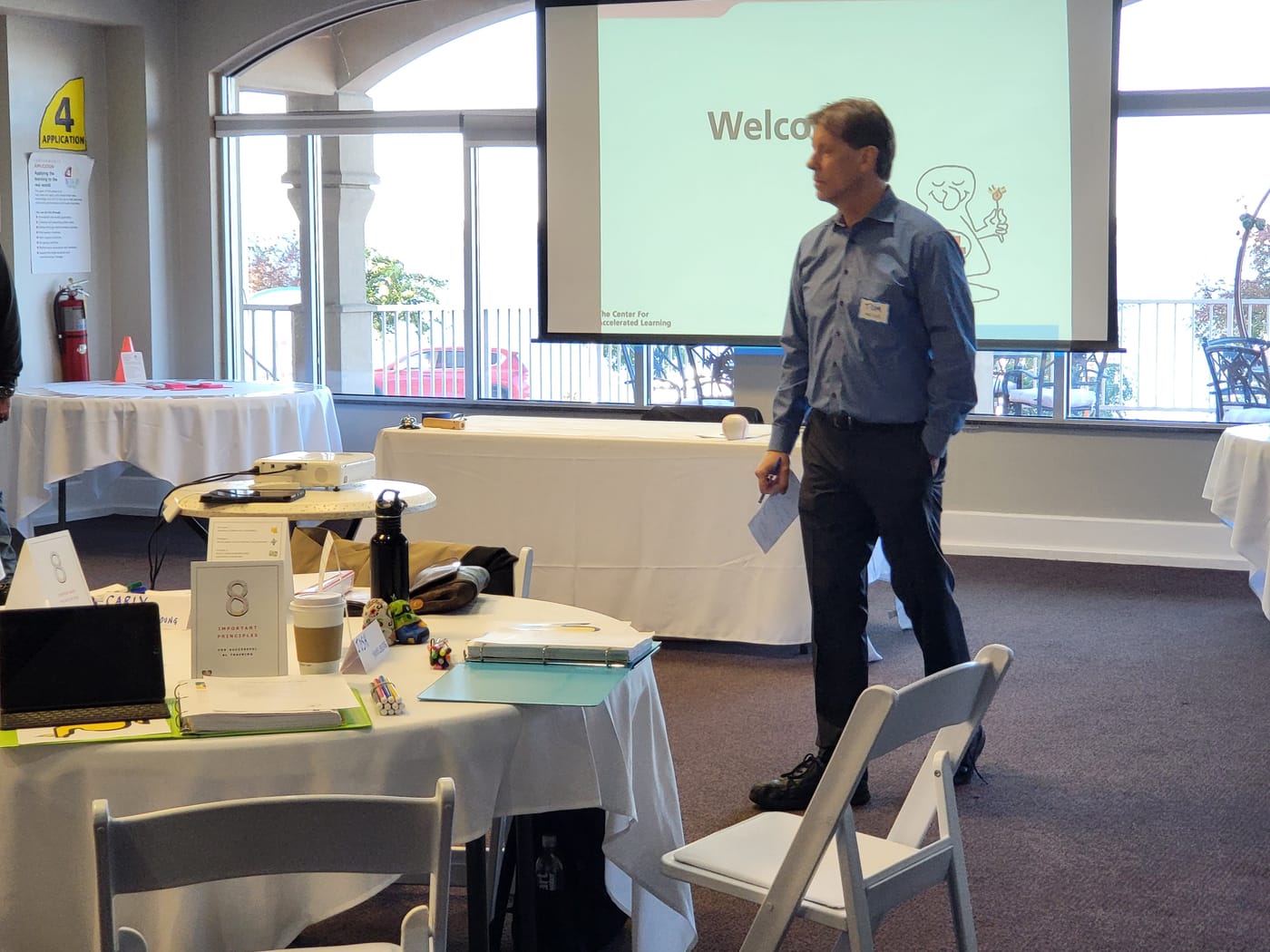 Tom Meier speaking at the front of the workshop room